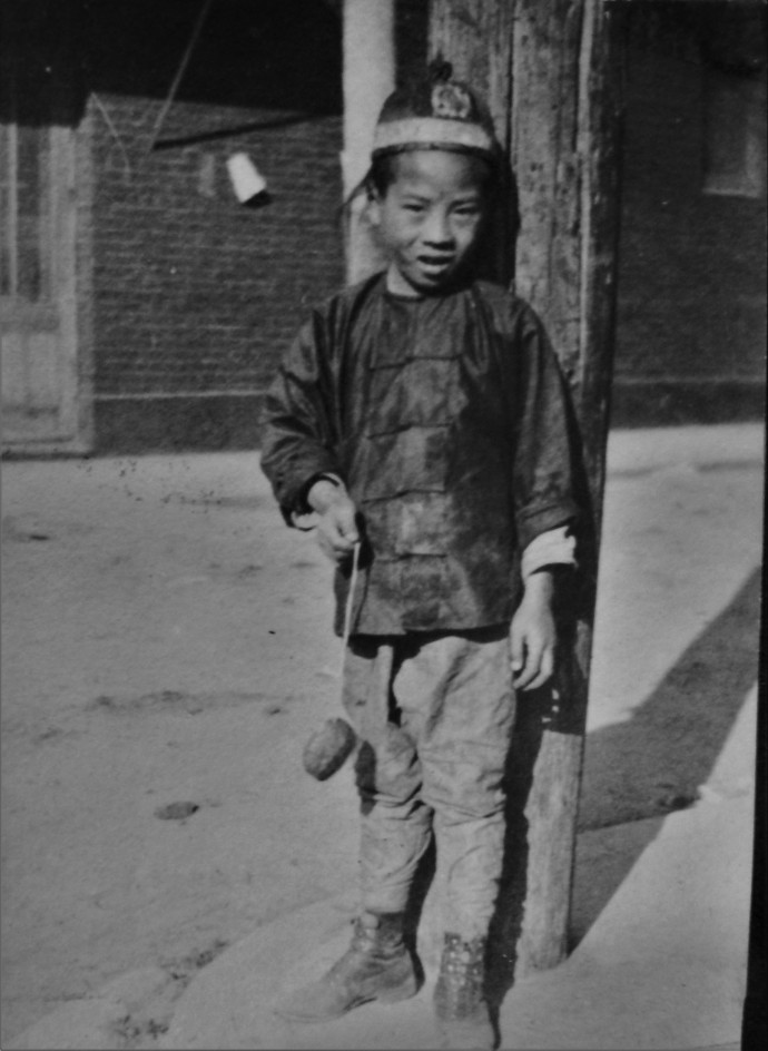 Chinese boy by pole